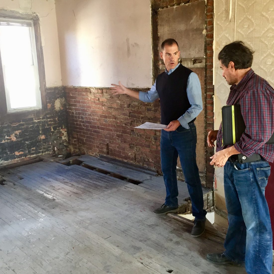 Joel consults with a contractor to prep a home for sale.
