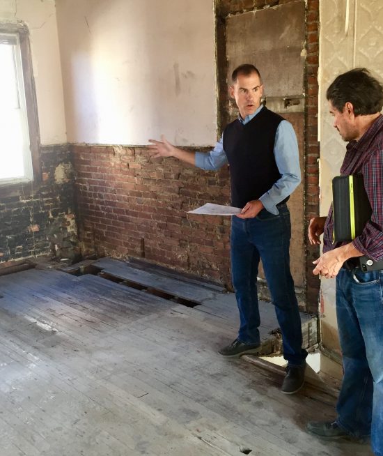 Joel consults with a contractor to prep a home for sale.